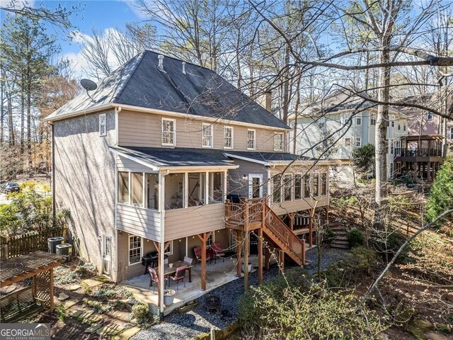 217 Colonial Dr, Woodstock, GA 30189 - rear view of house featuring a sunroom, stairs, a patio area, a deck, and a shingled roof