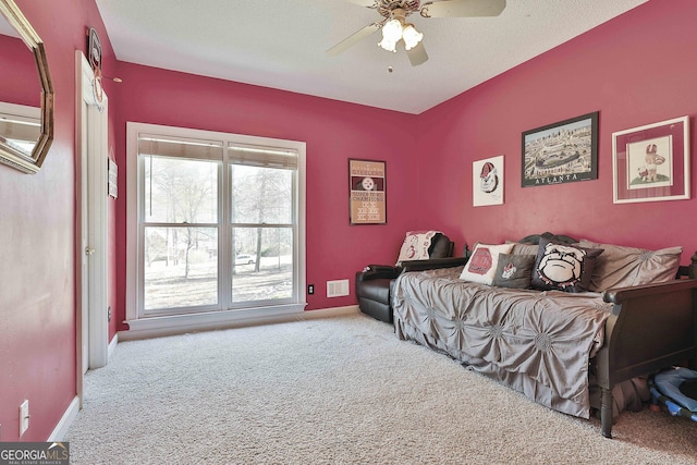 bedroom with visible vents, a textured ceiling, carpet, baseboards, and ceiling fan