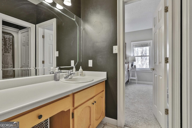 bathroom with baseboards and vanity