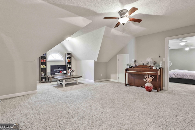 interior space with baseboards, a textured ceiling, carpet, and vaulted ceiling