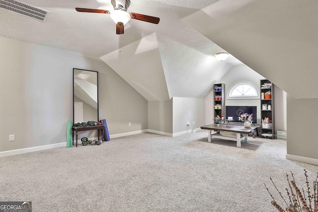 interior space with visible vents, carpet floors, a textured ceiling, and lofted ceiling