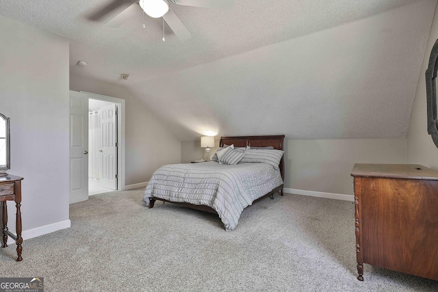 bedroom with baseboards, carpet floors, a textured ceiling, and lofted ceiling