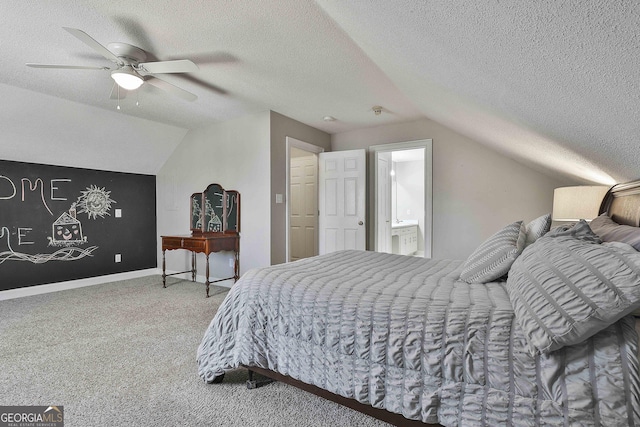 carpeted bedroom with baseboards, a textured ceiling, and vaulted ceiling