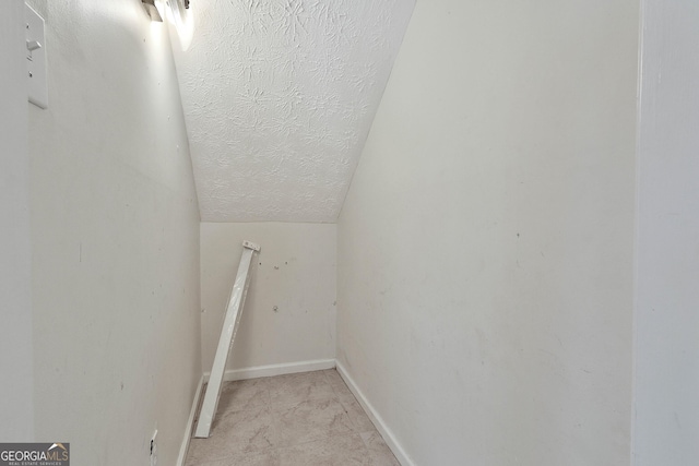 walk in closet with lofted ceiling