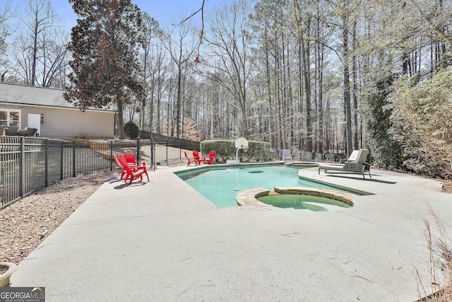 view of pool featuring a pool with connected hot tub, fence private yard, and a patio area