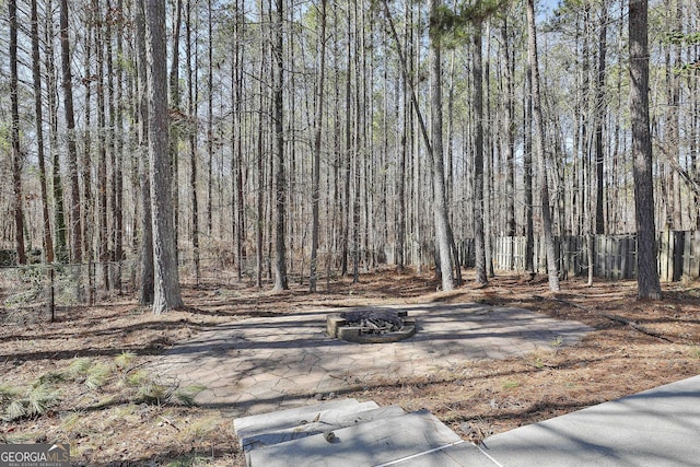 view of yard featuring a fire pit and fence