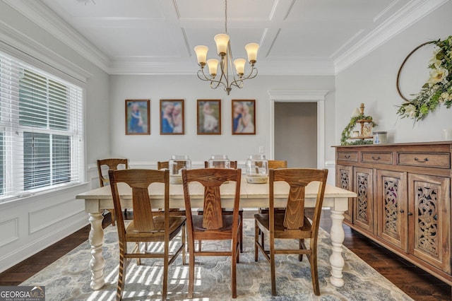 dining area featuring dark wood-type flooring, a chandelier, ornamental molding, and coffered ceiling