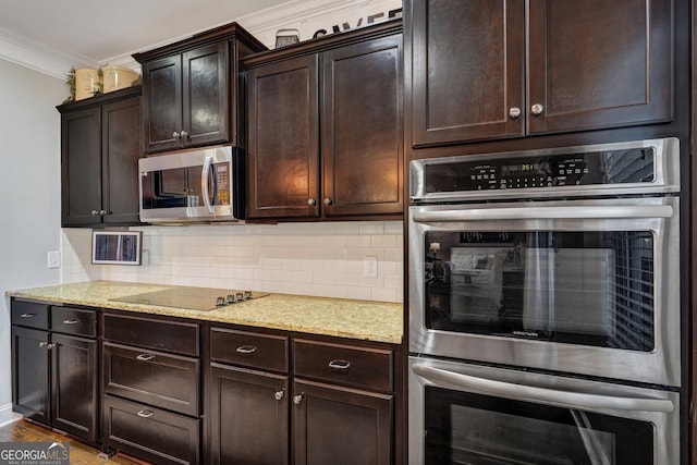 kitchen featuring light stone counters, ornamental molding, decorative backsplash, dark brown cabinetry, and stainless steel appliances