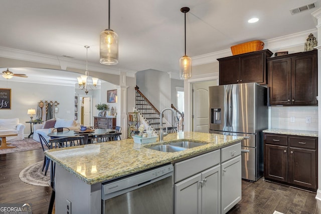 kitchen with visible vents, dark wood-type flooring, a sink, stainless steel appliances, and crown molding