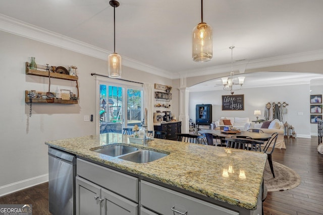 kitchen featuring an island with sink, decorative columns, dark wood-type flooring, dishwasher, and open floor plan