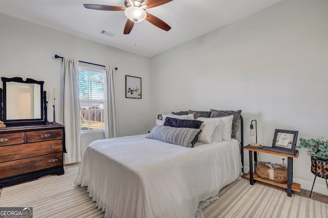 bedroom with baseboards, visible vents, and ceiling fan