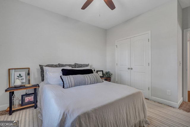 carpeted bedroom featuring baseboards, a closet, and ceiling fan