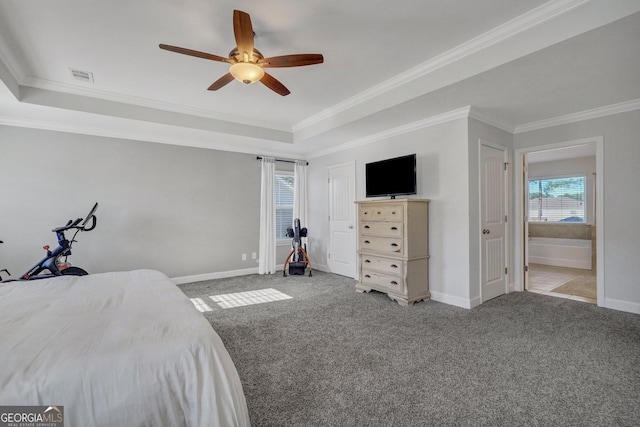 carpeted bedroom with visible vents, ornamental molding, a ceiling fan, a tray ceiling, and baseboards