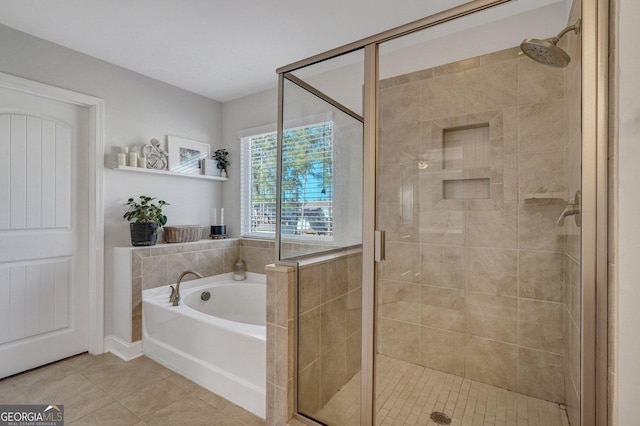 full bathroom featuring tile patterned flooring, a stall shower, and a garden tub