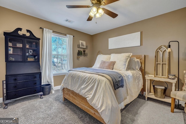 carpeted bedroom featuring visible vents, ceiling fan, and baseboards