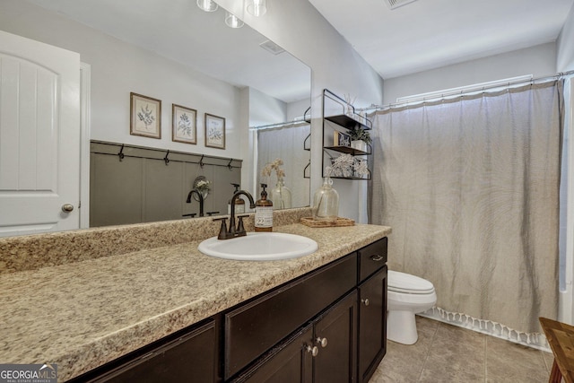 bathroom with a shower with shower curtain, toilet, vanity, and tile patterned flooring