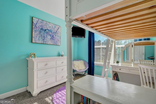 carpeted bedroom featuring baseboards