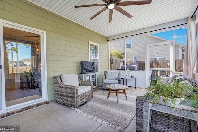 view of patio featuring ceiling fan and fence