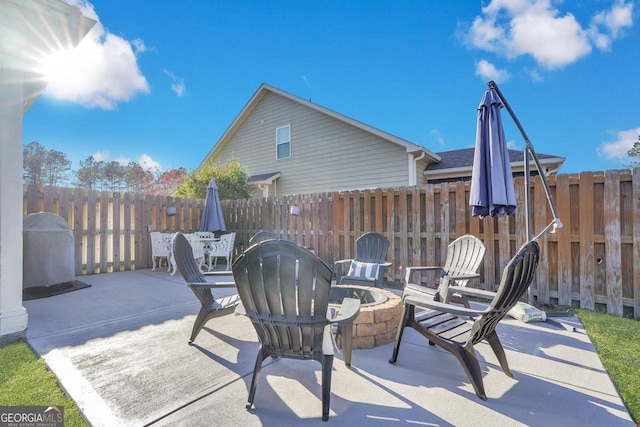 view of patio featuring fence and an outdoor fire pit