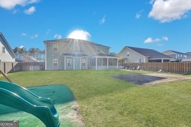 back of property featuring a patio, a lawn, a fenced backyard, and a sunroom