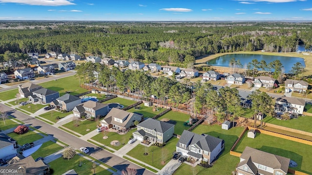 bird's eye view featuring a residential view, a view of trees, and a water view