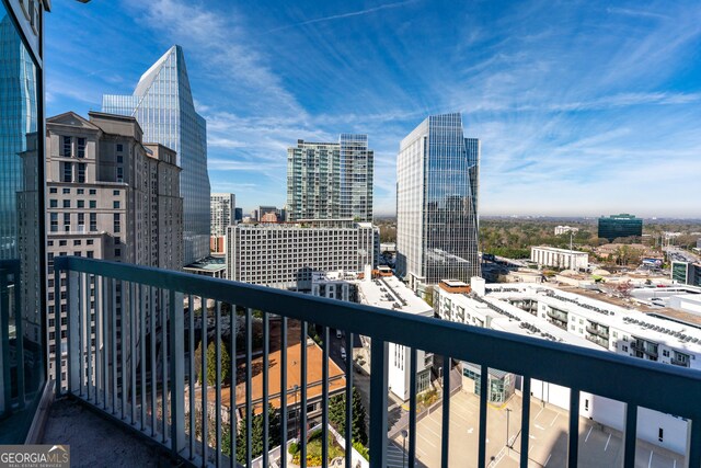 empty room with a wall of windows, a view of city, a healthy amount of sunlight, and visible vents
