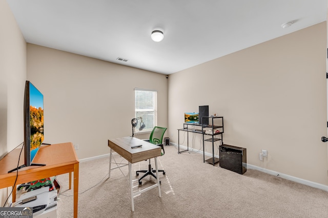carpeted office with baseboards and visible vents
