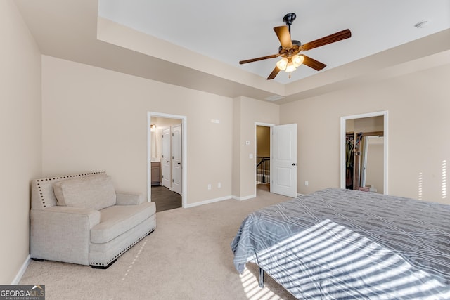 carpeted bedroom with a walk in closet, ensuite bath, baseboards, visible vents, and a closet