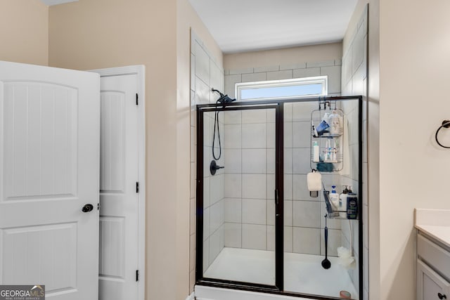 full bathroom with vanity and a shower stall