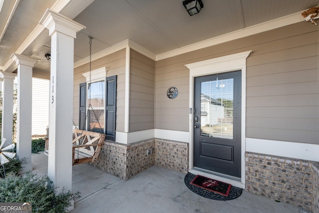 view of exterior entry with covered porch