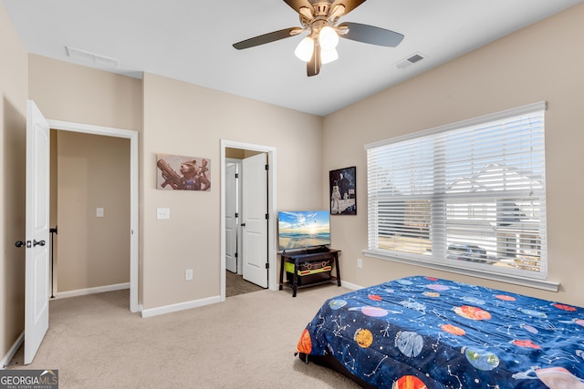 carpeted bedroom with baseboards, visible vents, and ceiling fan