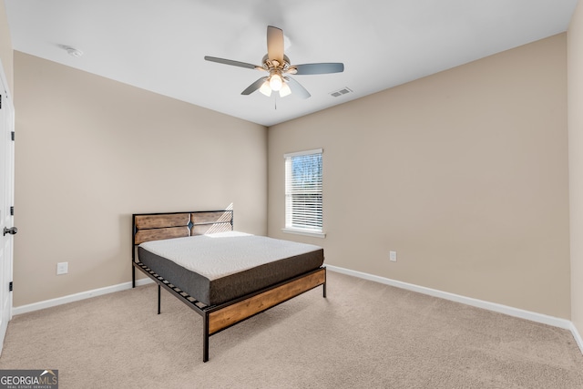 bedroom featuring baseboards and light colored carpet