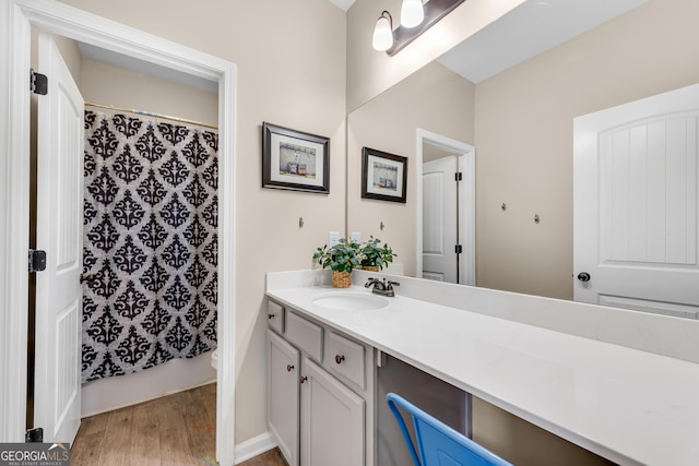 bathroom featuring vanity, a shower with curtain, toilet, and wood finished floors