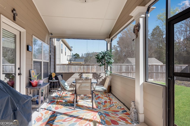 sunroom featuring outdoor dining space and a wealth of natural light
