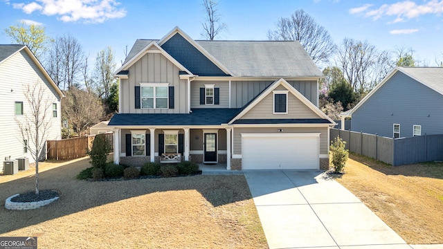 craftsman house featuring fence, board and batten siding, a porch, and driveway