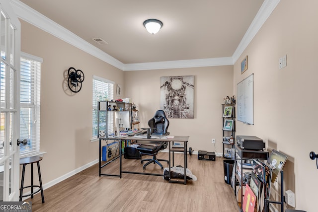 home office featuring baseboards, visible vents, ornamental molding, and light wood-style flooring
