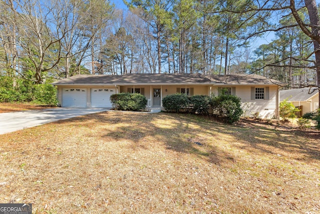 single story home featuring concrete driveway, a garage, and a front lawn