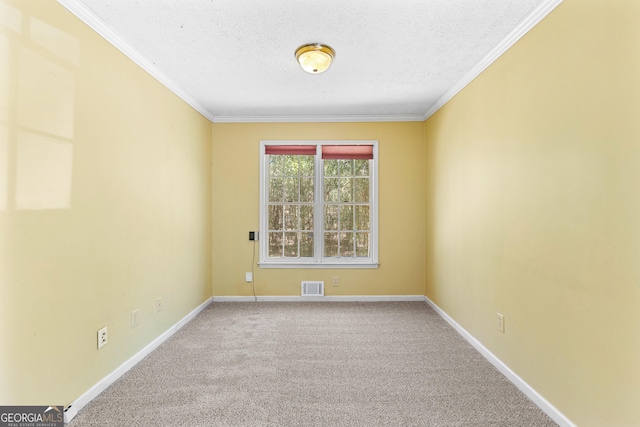 carpeted spare room with visible vents, baseboards, a textured ceiling, and ornamental molding