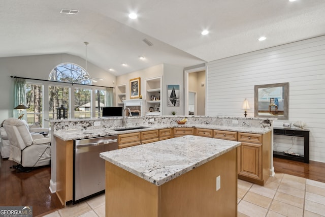 246 Heron Ct, Saint Marys, GA 31558 - kitchen with a center island, light stone countertops, open floor plan, dishwasher, and a sink