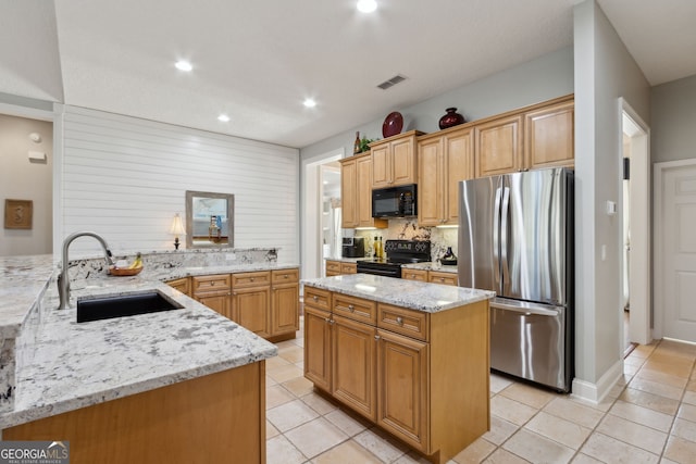 246 Heron Ct, Saint Marys, GA 31558 - kitchen with light stone counters, visible vents, a sink, black appliances, and tasteful backsplash