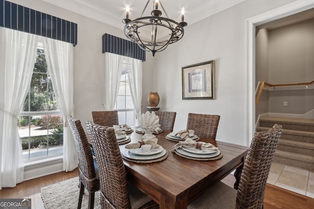 246 Heron Ct, Saint Marys, GA 31558 - dining space featuring stairs, ornamental molding, wood finished floors, and a chandelier