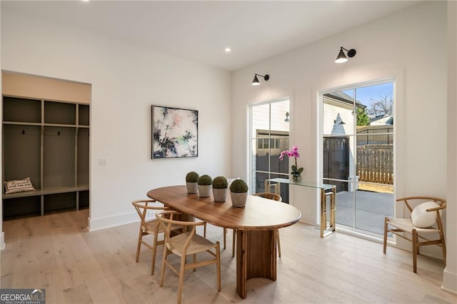 dining room with recessed lighting, baseboards, and light wood finished floors