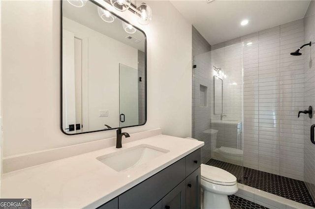 full bath with toilet, a stall shower, and vanity