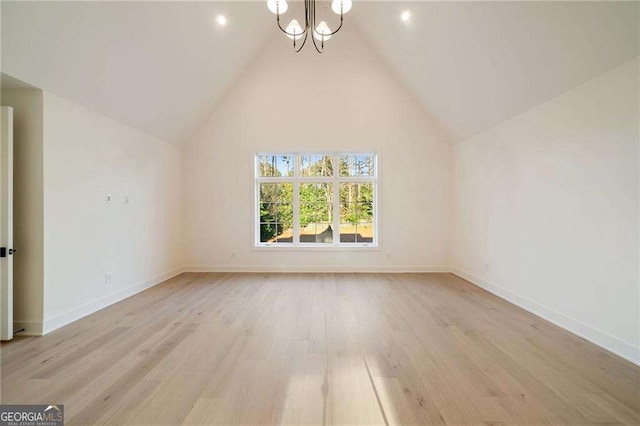 additional living space with an inviting chandelier, baseboards, light wood-type flooring, and high vaulted ceiling