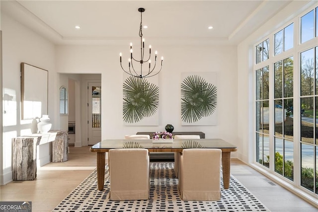 dining area featuring recessed lighting, light wood-style flooring, visible vents, and an inviting chandelier