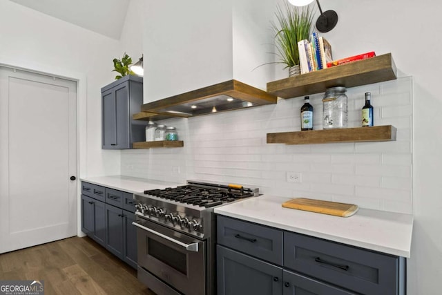 kitchen with gray cabinetry, open shelves, dark wood-style floors, decorative backsplash, and high end range