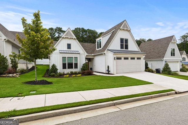modern inspired farmhouse featuring driveway, a standing seam roof, a front lawn, board and batten siding, and metal roof