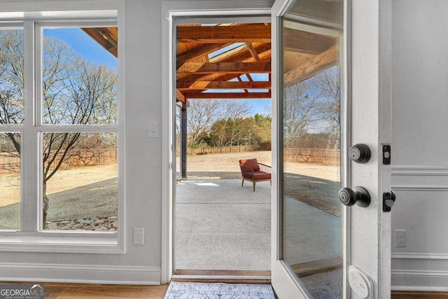 doorway to outside with baseboards