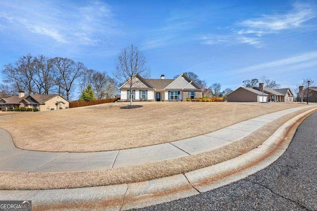 view of front of property with a front lawn and fence