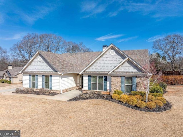 view of front of home featuring a chimney and a shingled roof